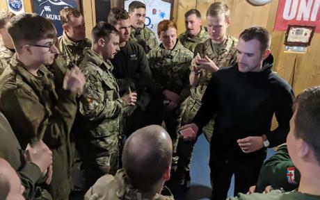 Magician performing in front of Armed Forces audience.
