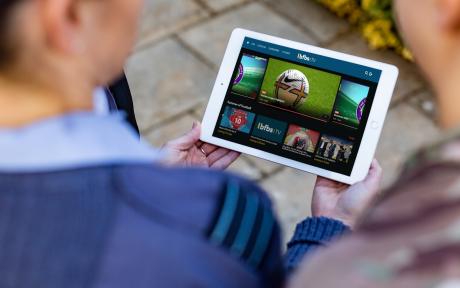 Close up of serving personnel using a smart device to use the BFBS TV Player app.